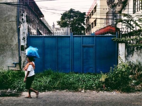 Woman walking on the sidewalk.
