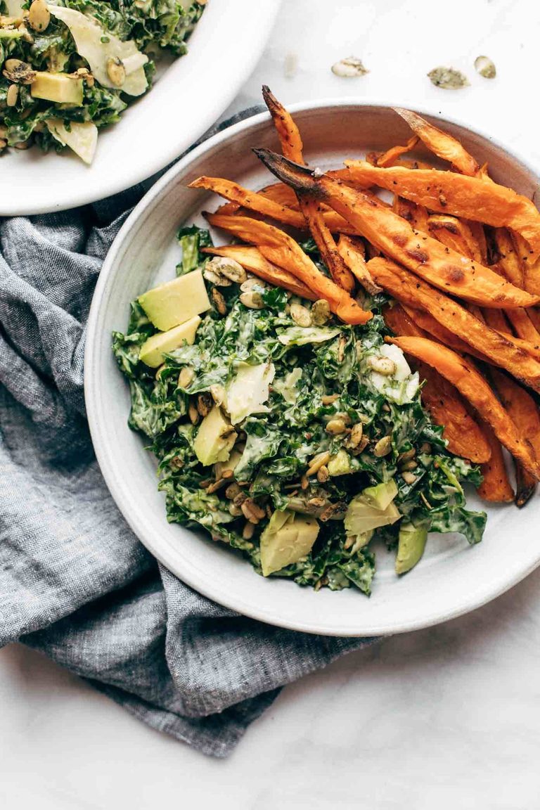 Kale salad with sweet potato fries.
