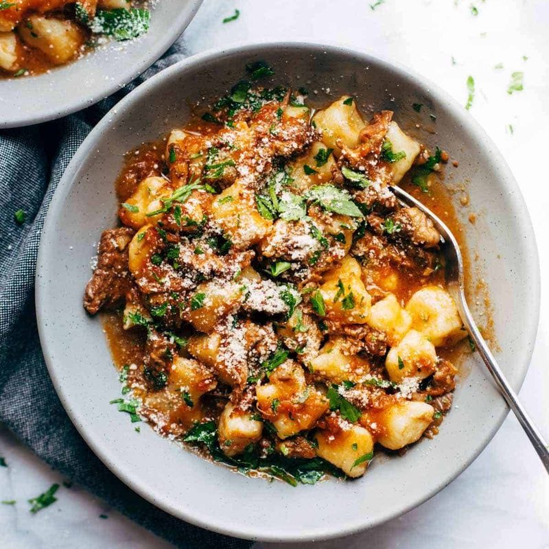 Short Rib Ragu in bowls with fork.