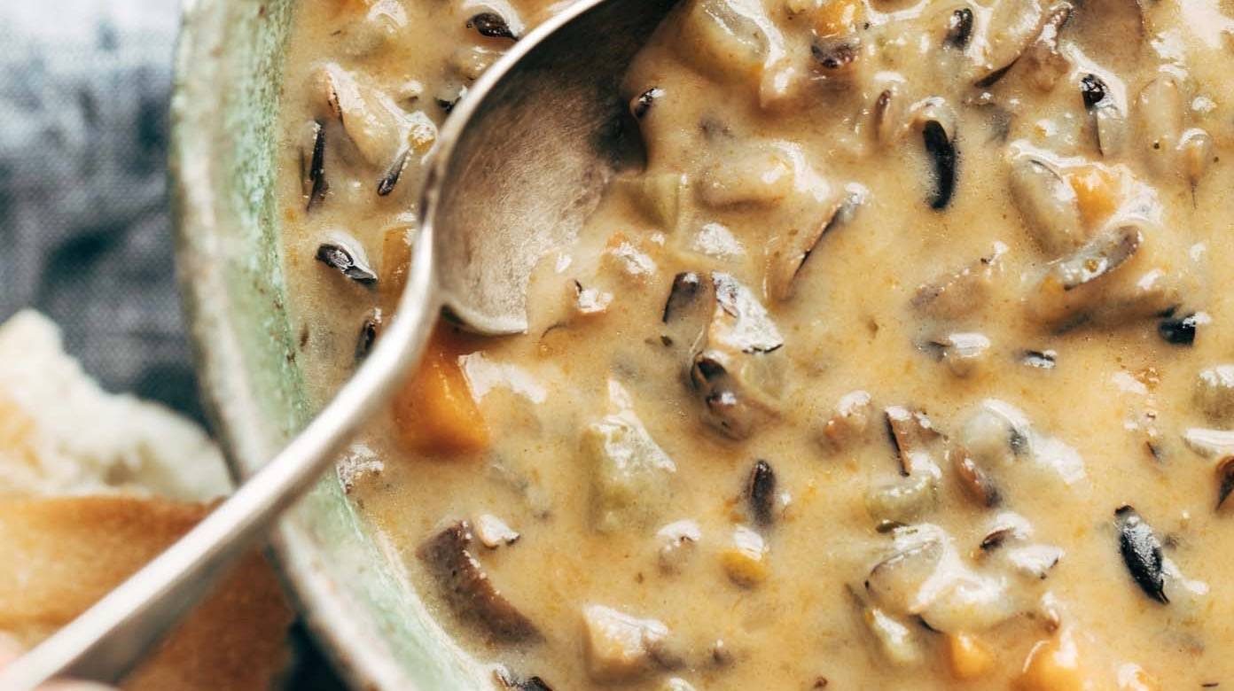 Instant Pot Wild Rice soup in bowl with spoon.