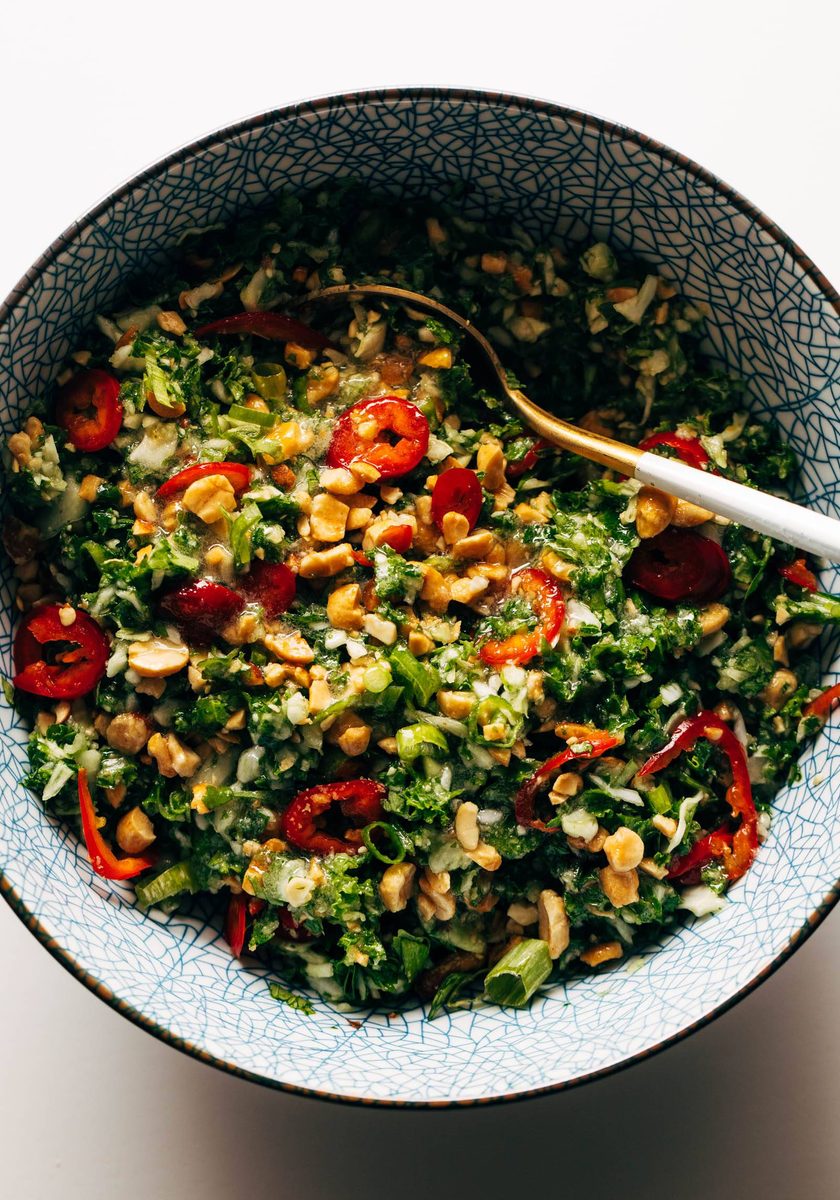 Peanut kale salad in a bowl with a spoon