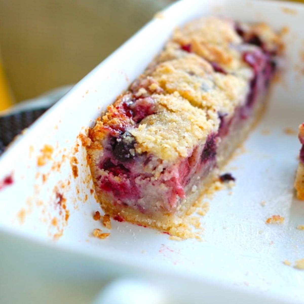 Triple berry pie bars in a white dish.